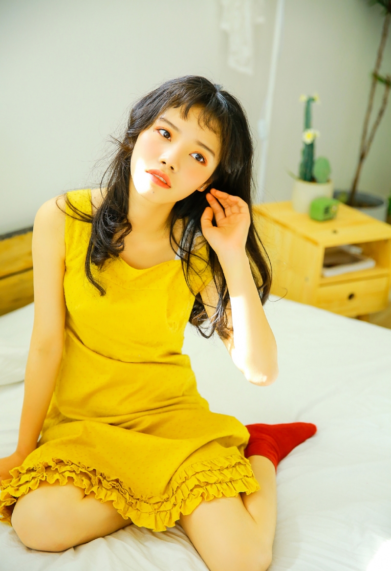 床上美女黄色吊裙明媚娇俏图片