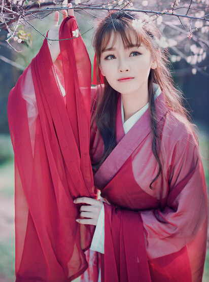 红衣少女户外赏梅图片  五官清秀
