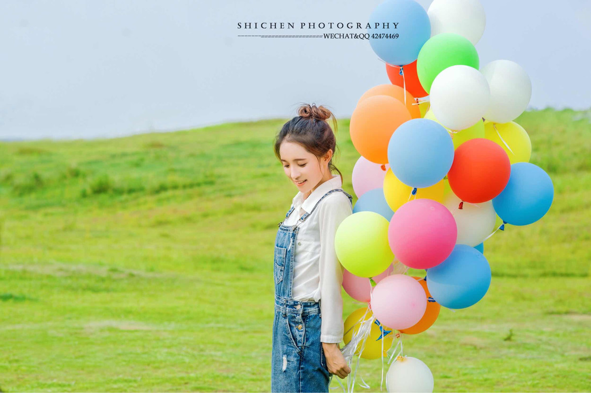 玩气球的牛仔裤背带女孩